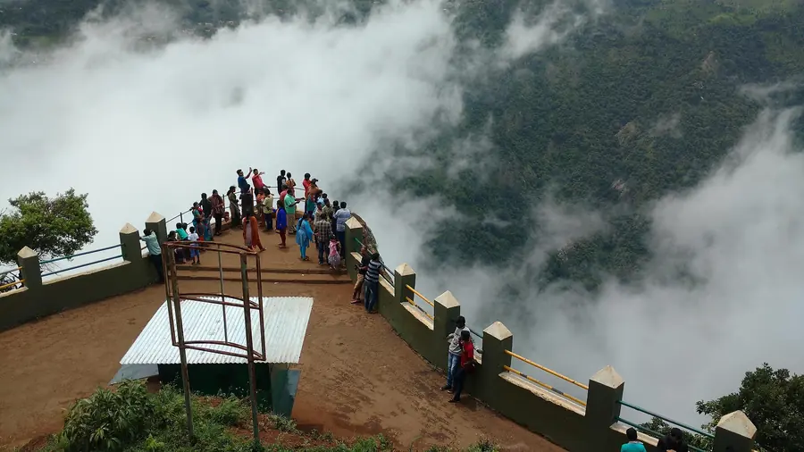Visitors at Dolphin's Nose viewpoint, Coonoor, with clouds in the valley